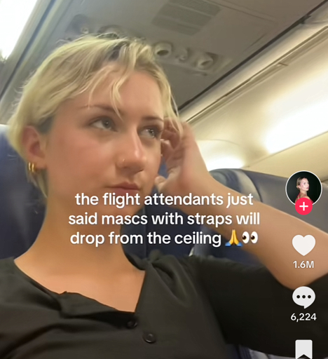 Person sitting in an airplane seat playing flirtatiously with their hair. The caption says that the flight attendant just said mascs (with a c) with straps will drop from the ceiling.